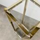 Gilded metal fifth wheel column and Hollywood Regency style glass 70s