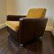Vintage brown / ochre armchair / a chair on wheels
