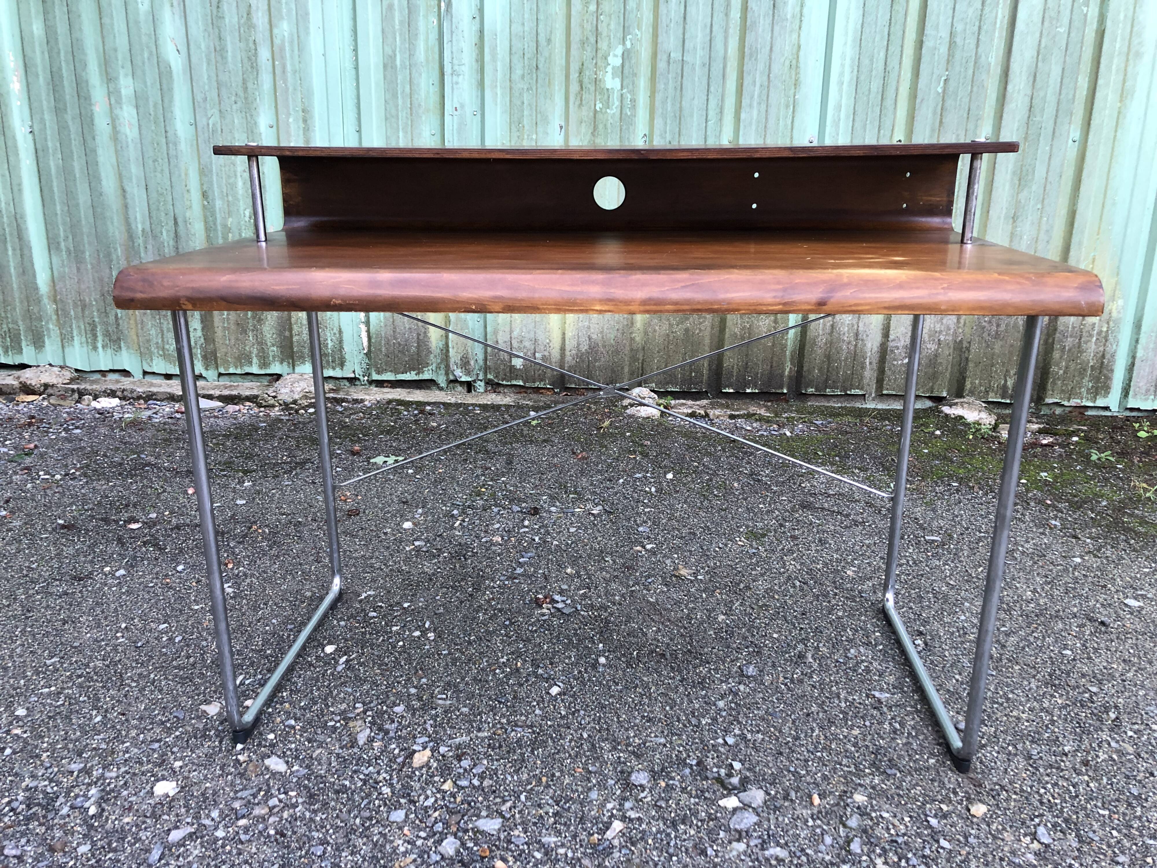 Design desk in formed glued laminated wood with chrome tubular base.
