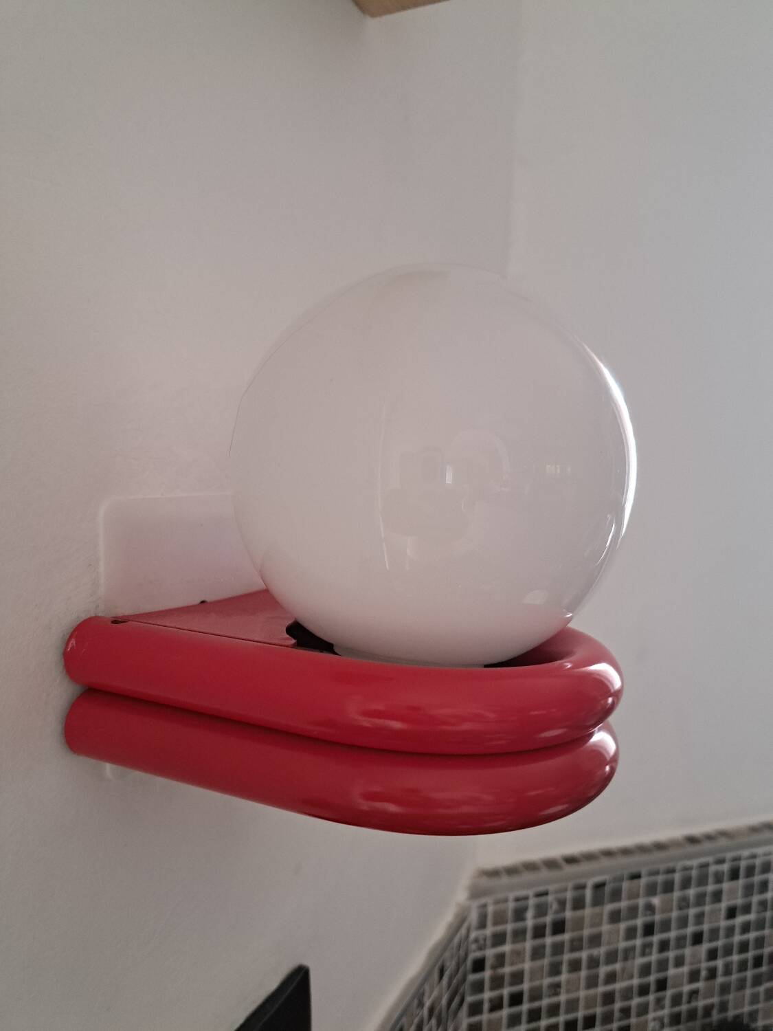 Red metal globe wall light