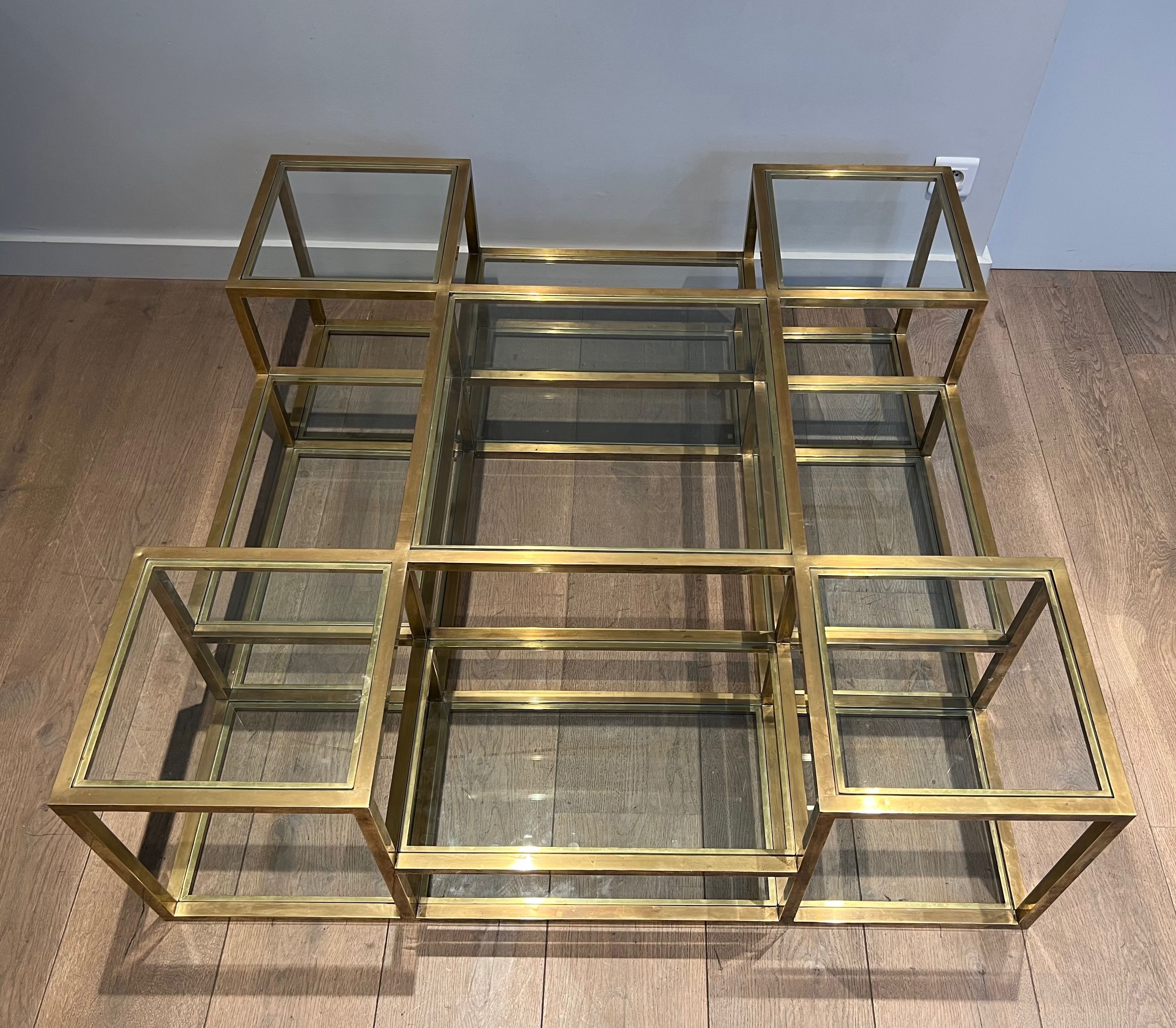 Important brass coffee table with multiple levels.