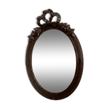 Antique oval mirror in carved wood and Louis XVI style knot