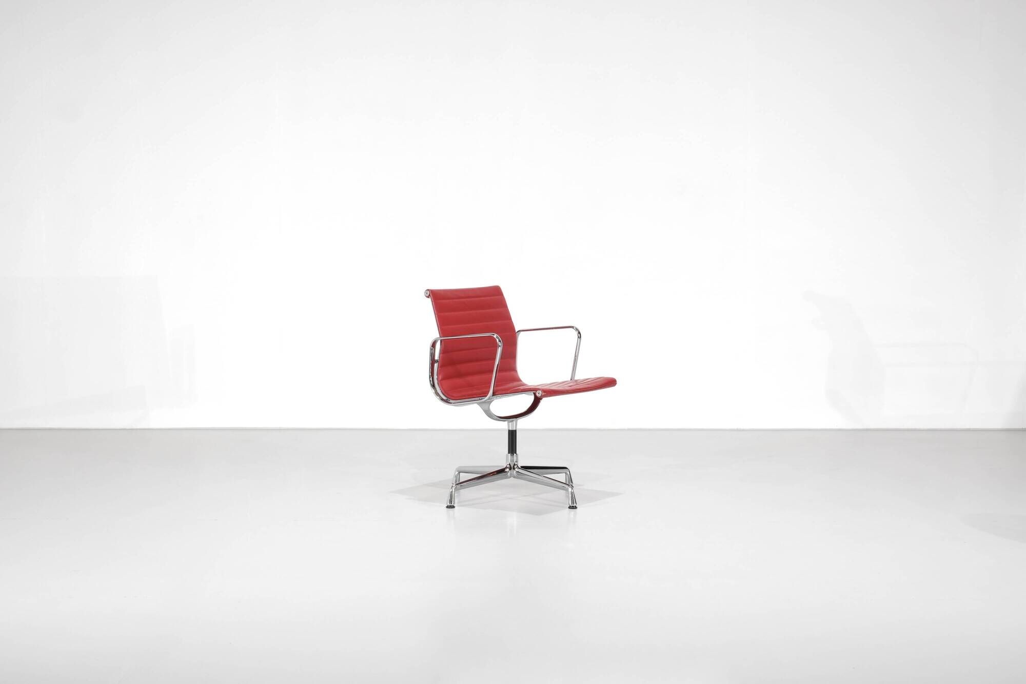 "EA 108" armchair in red leather, designed by Charles and Ray Eames for Vitra,