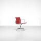 "EA 108" armchair in red leather, designed by Charles and Ray Eames for Vitra,