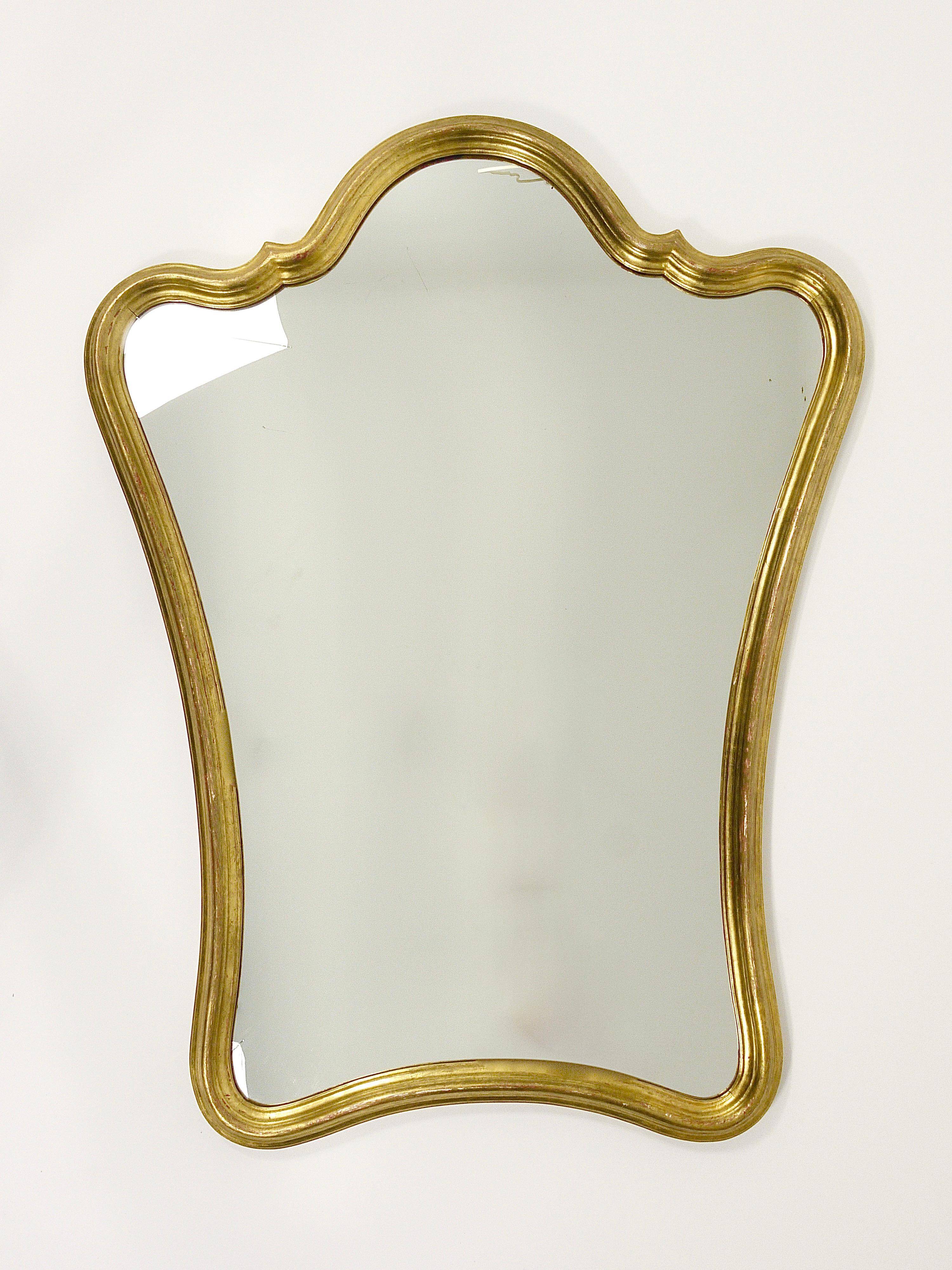 Curved wall mirror in gilded wood Chelini Firenze, mid-century, Italy, 1950s.