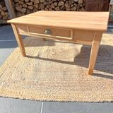 Low farmhouse table in raw wood