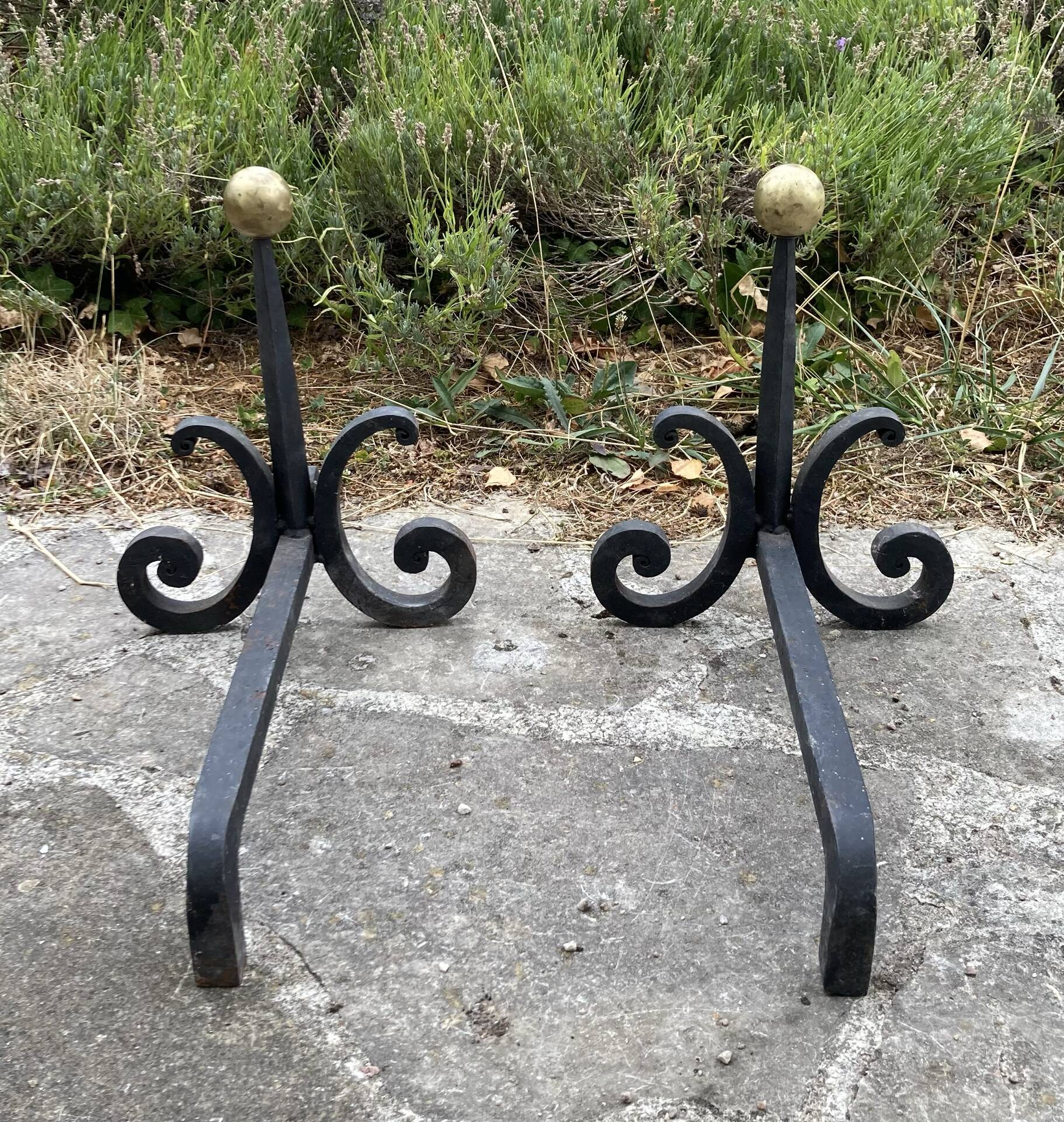 Massive wrought iron chenets from the 19th century topped with brass balls.