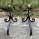 Massive wrought iron chenets from the 19th century topped with brass balls.