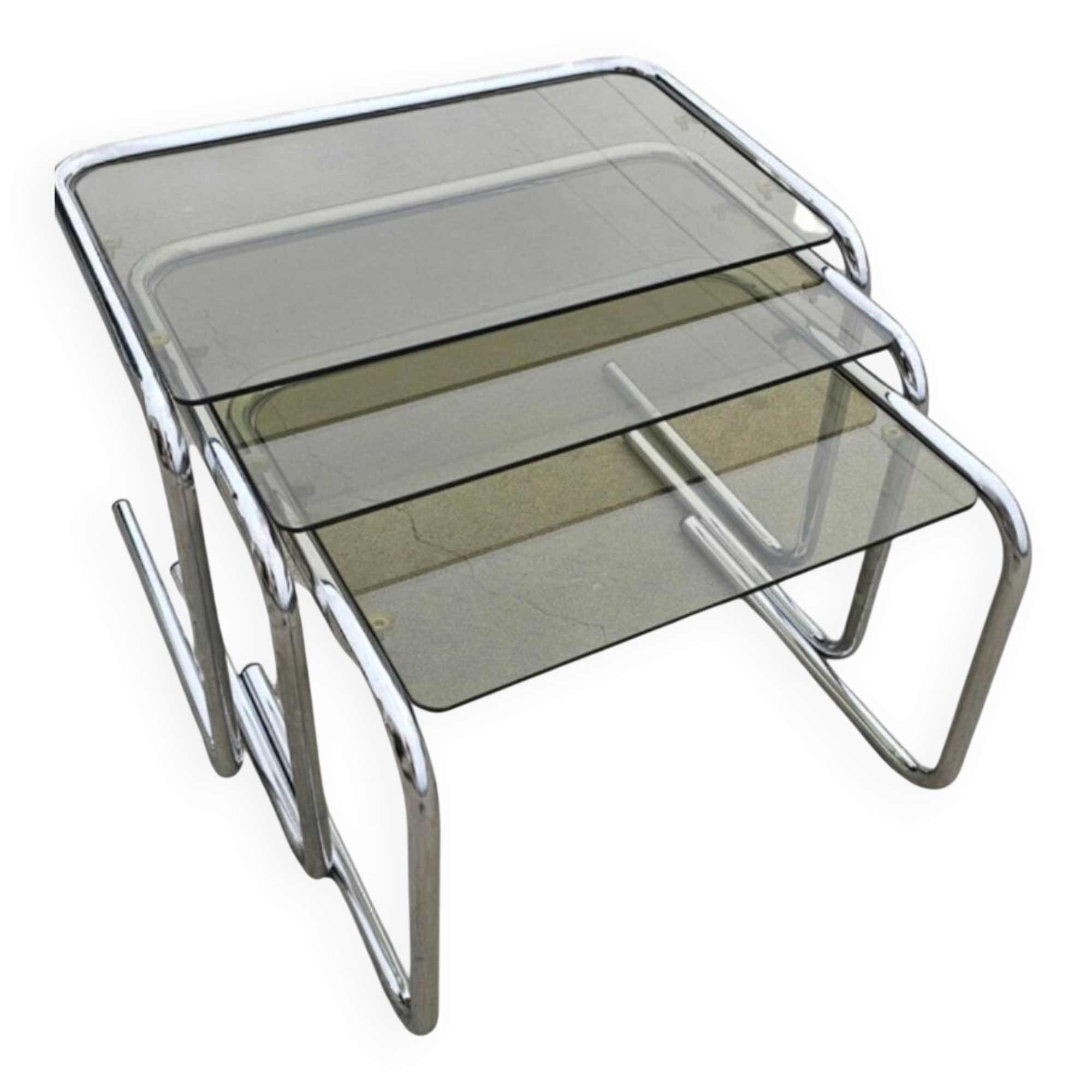 Nest tables in chrome metal and tinted glass.