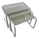 Nest tables in chrome metal and tinted glass.