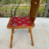 2 curved wood and red fabric chairs