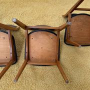 4 Scandinavian chairs in teak and black faux leather.