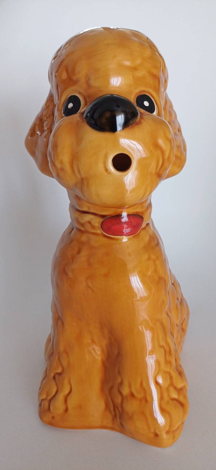 Ancient ceramic pitcher in the shape of a poodle.