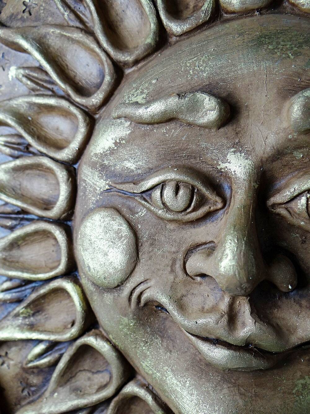 Anthropomorphic sun wall sculpture in patinated terracotta, vintage Italian craftsmanship.