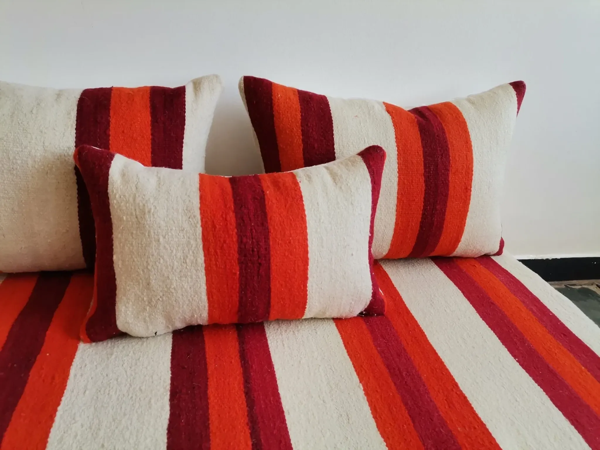 Set of covers for cream and red Moroccan floor sofa.