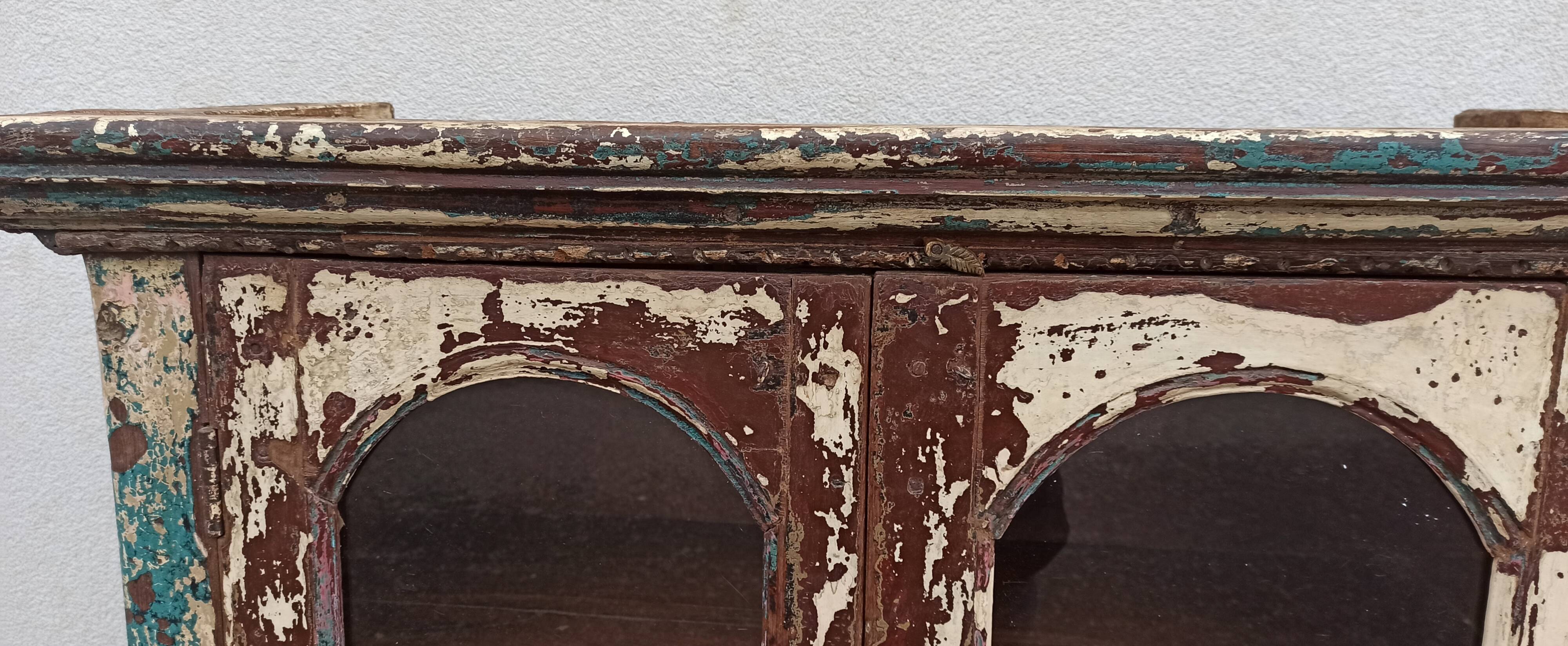 Old patinated wooden glass cabinet