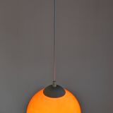 Pair of spherical pendant lights in orange opaline, France circa 1970.