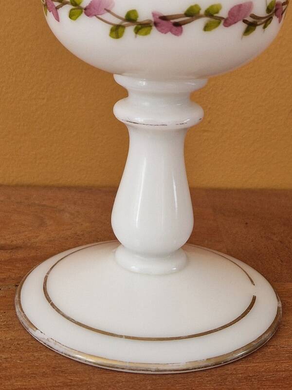 Footed glass in the shape of a chalice in white opaline with a floral decoration.