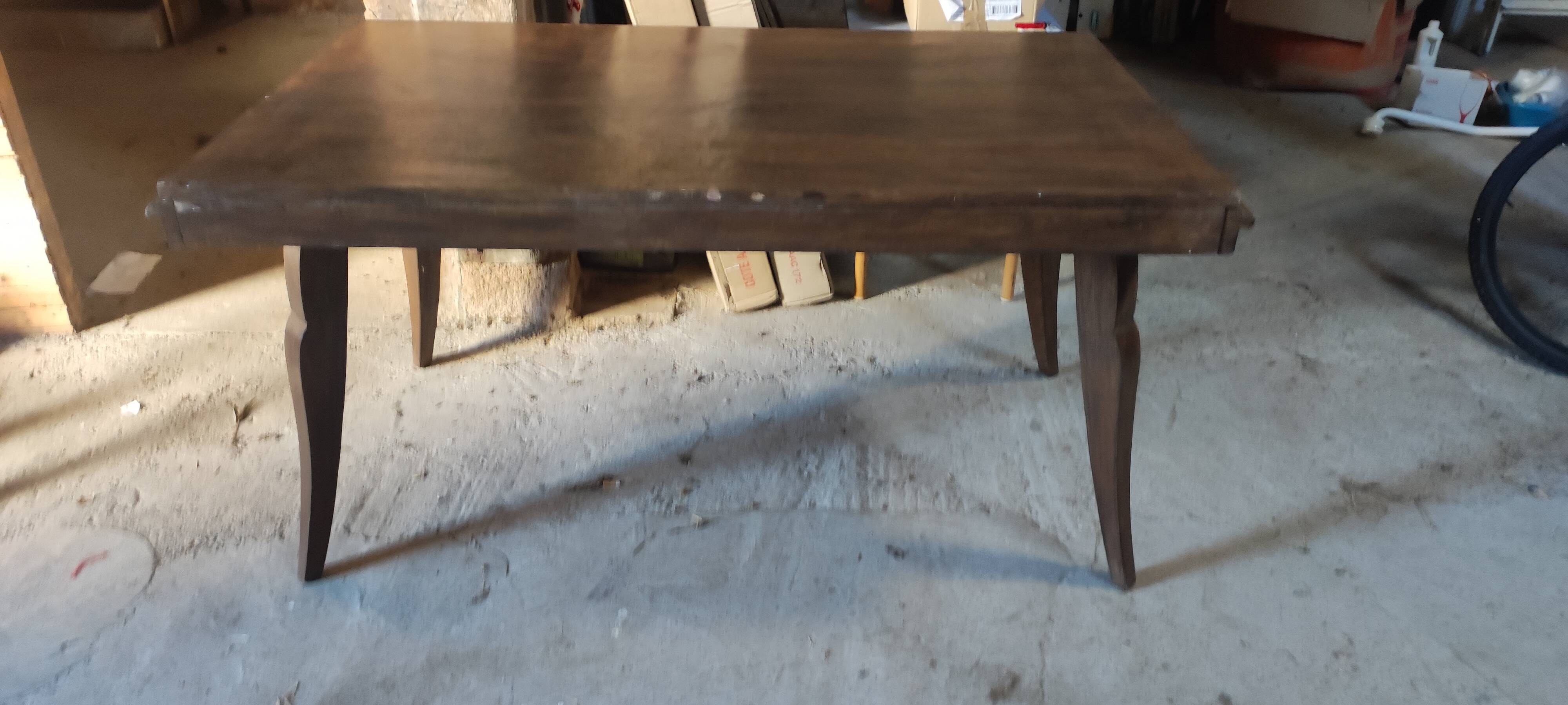 Solid oak dining table with integrated extensions.