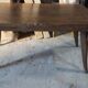 Solid oak dining table with integrated extensions.