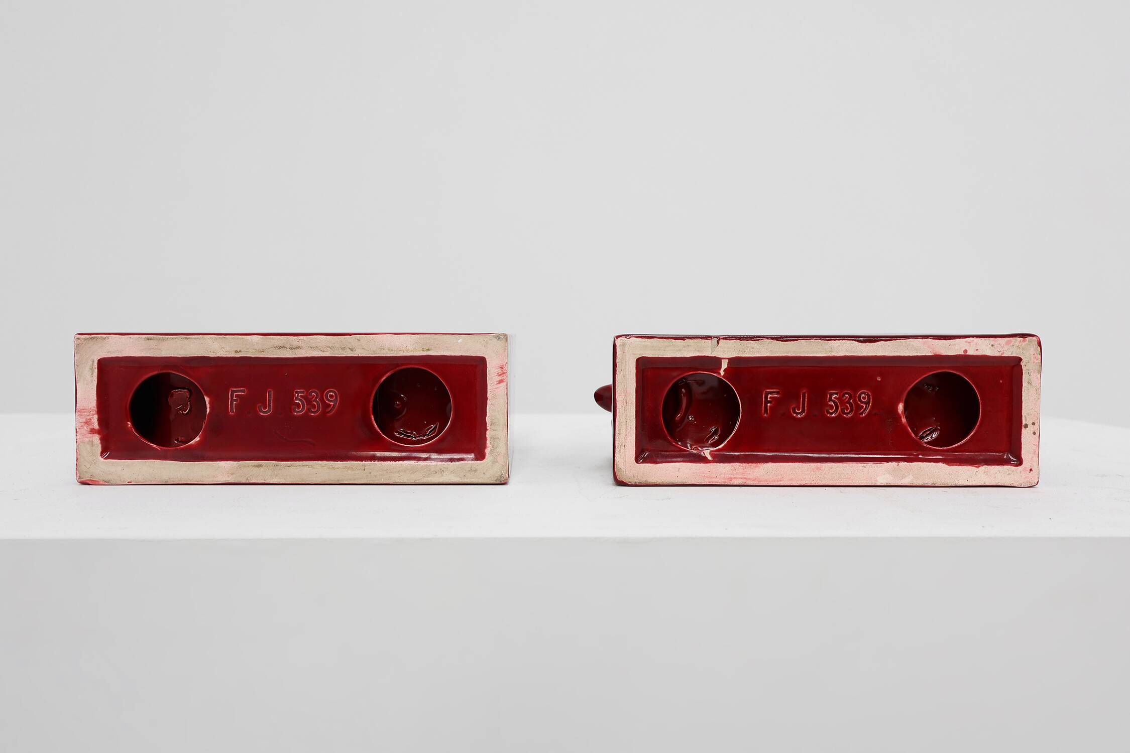 Pair of red glazed ceramic Bison ox bookends in Art Deco style, Belgium
