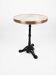 Bistro table with a marble top and brass, cast iron base.