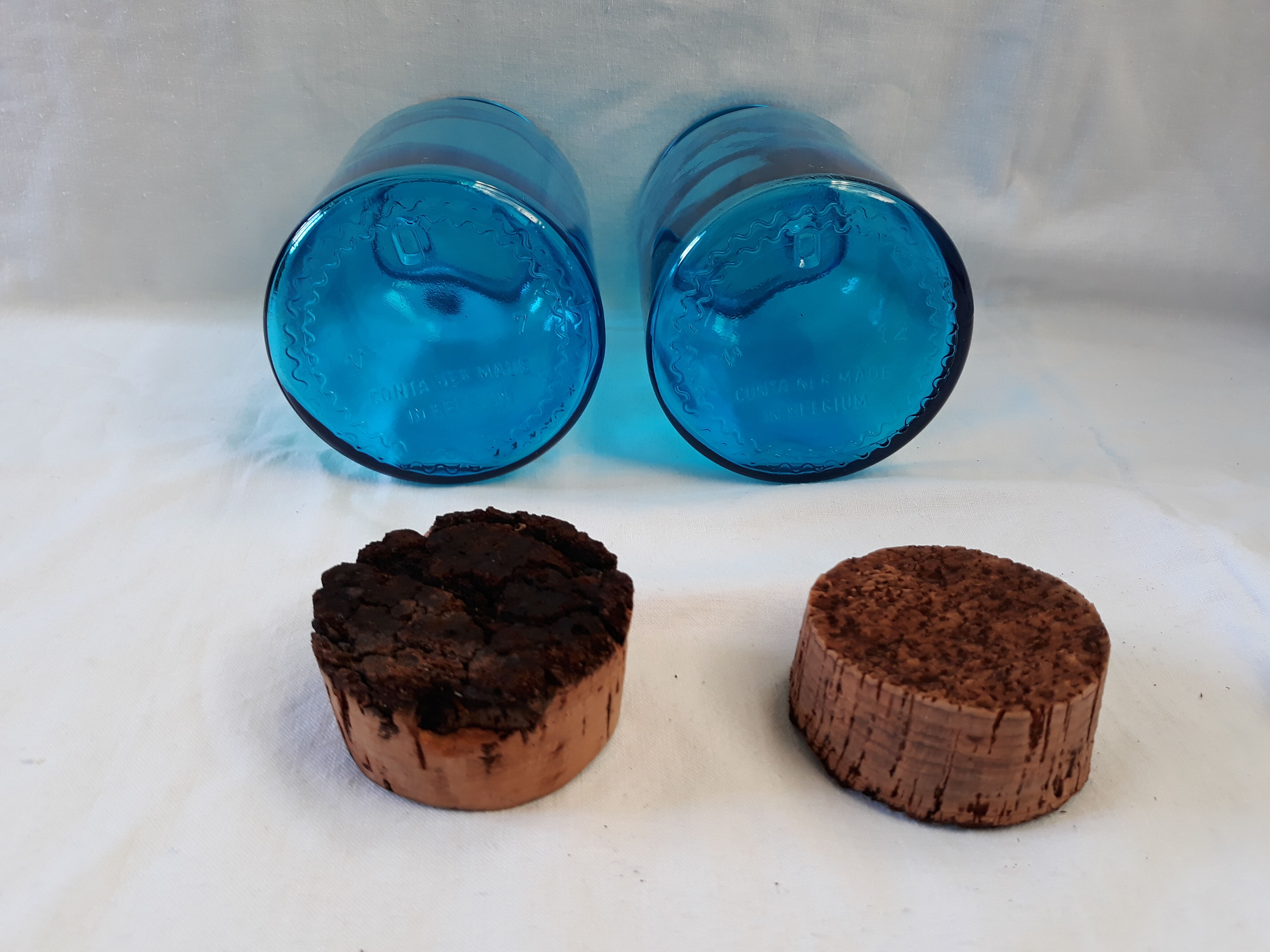 pair of apothecary vials in blue glass jar