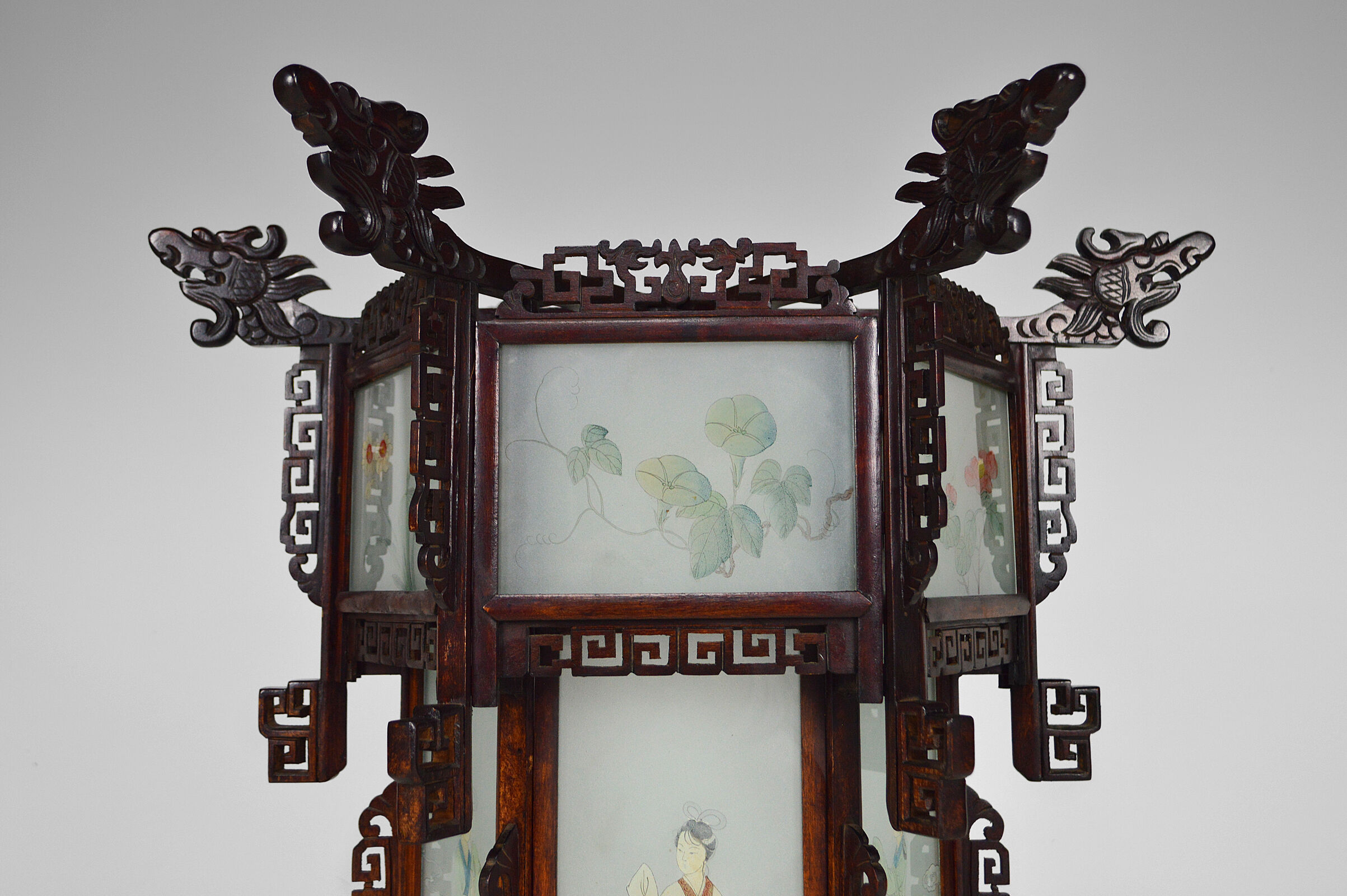 Asian wooden lantern carved with dragons and painted glass panels