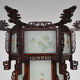Asian wooden lantern carved with dragons and painted glass panels