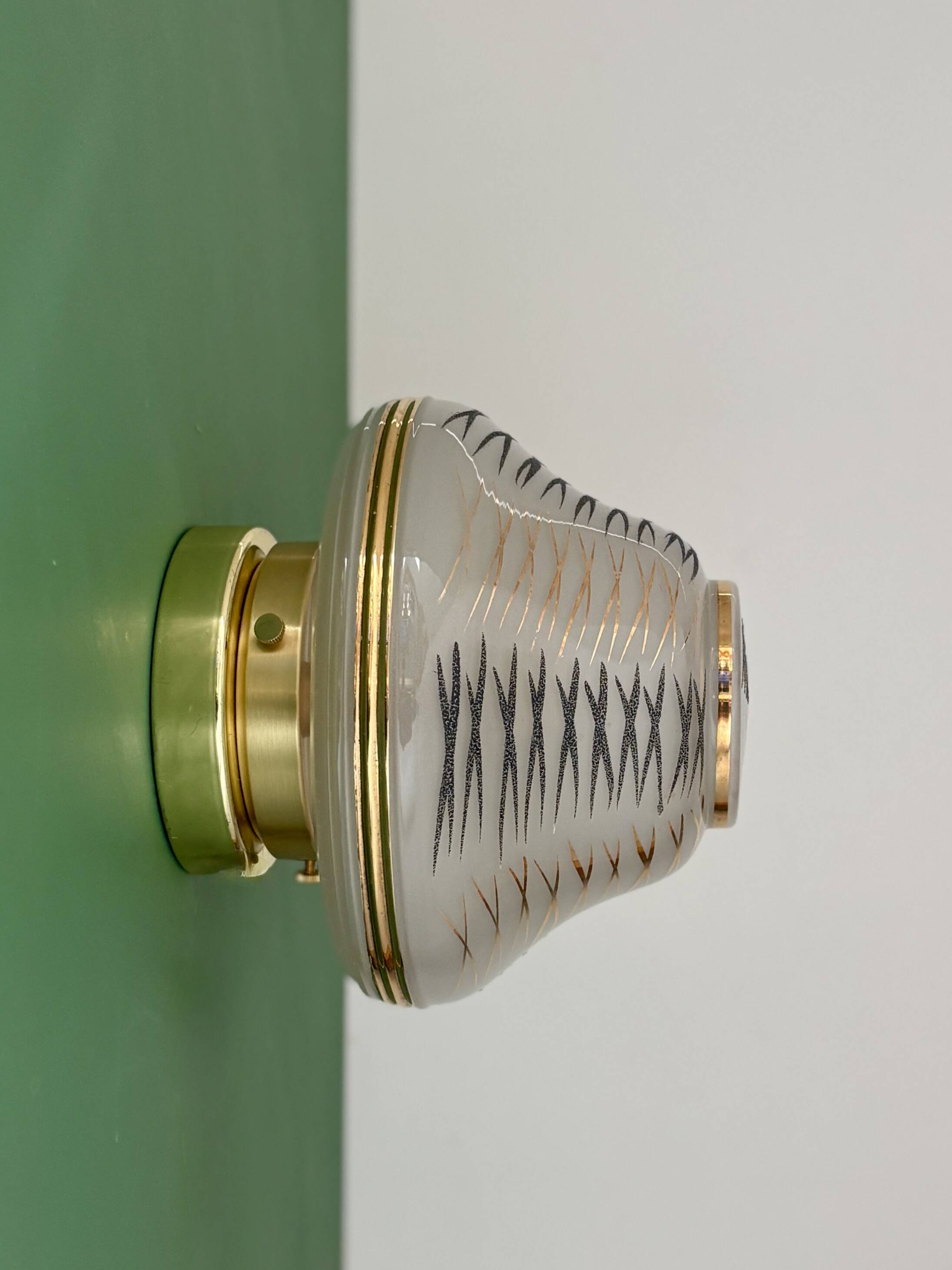 Vintage Art Deco globe wall/ceiling light in white, black, and gold glass.