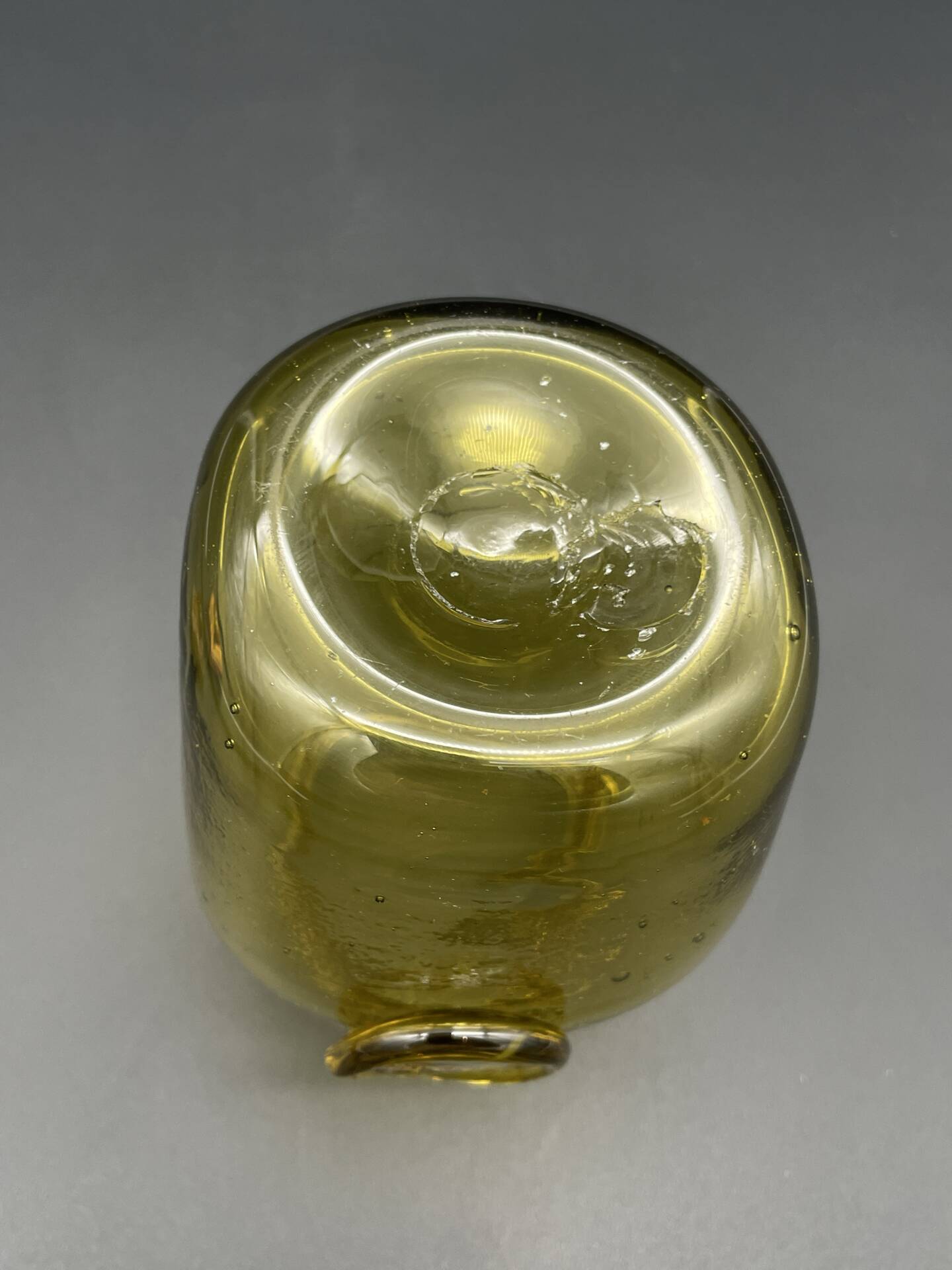 Yellow bubbled glass apothecary jar with cork lid.