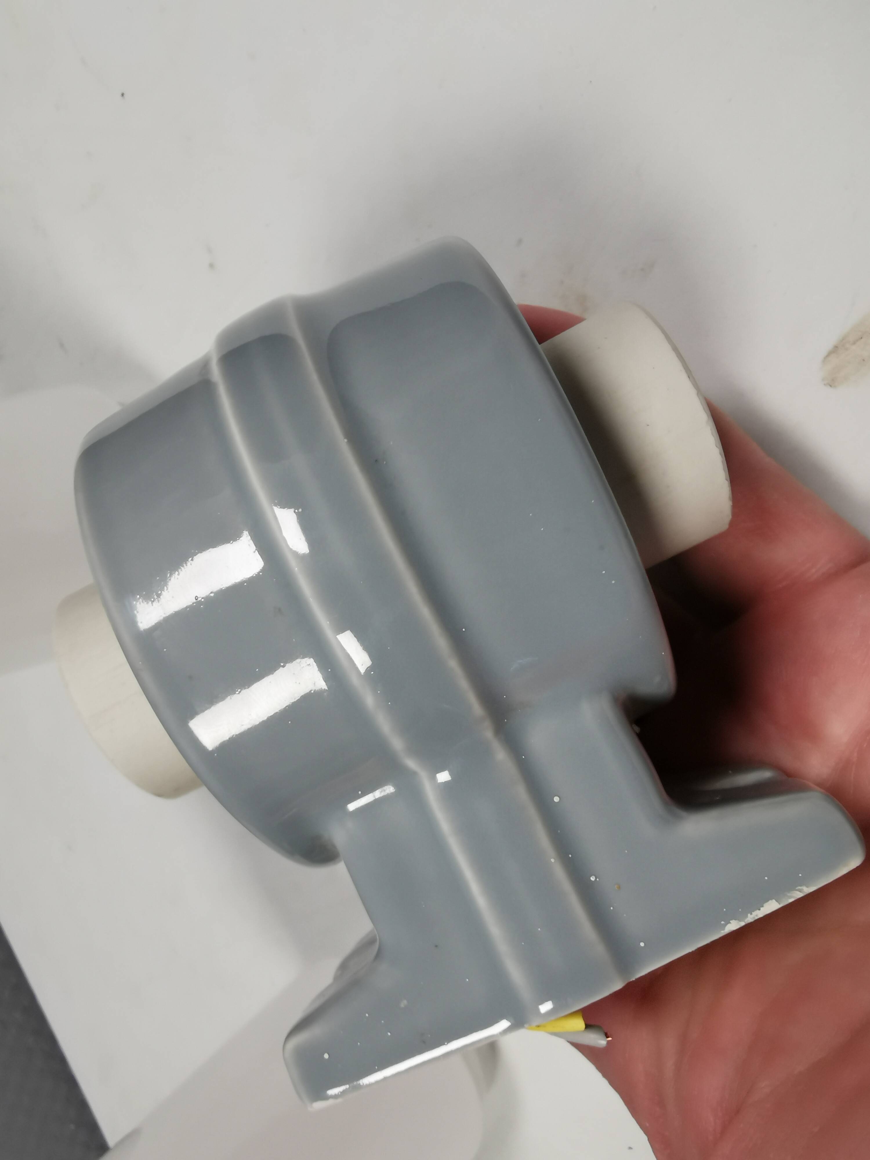 Bathroom lamp with light gray ceramic base,  and milky white opal glass.