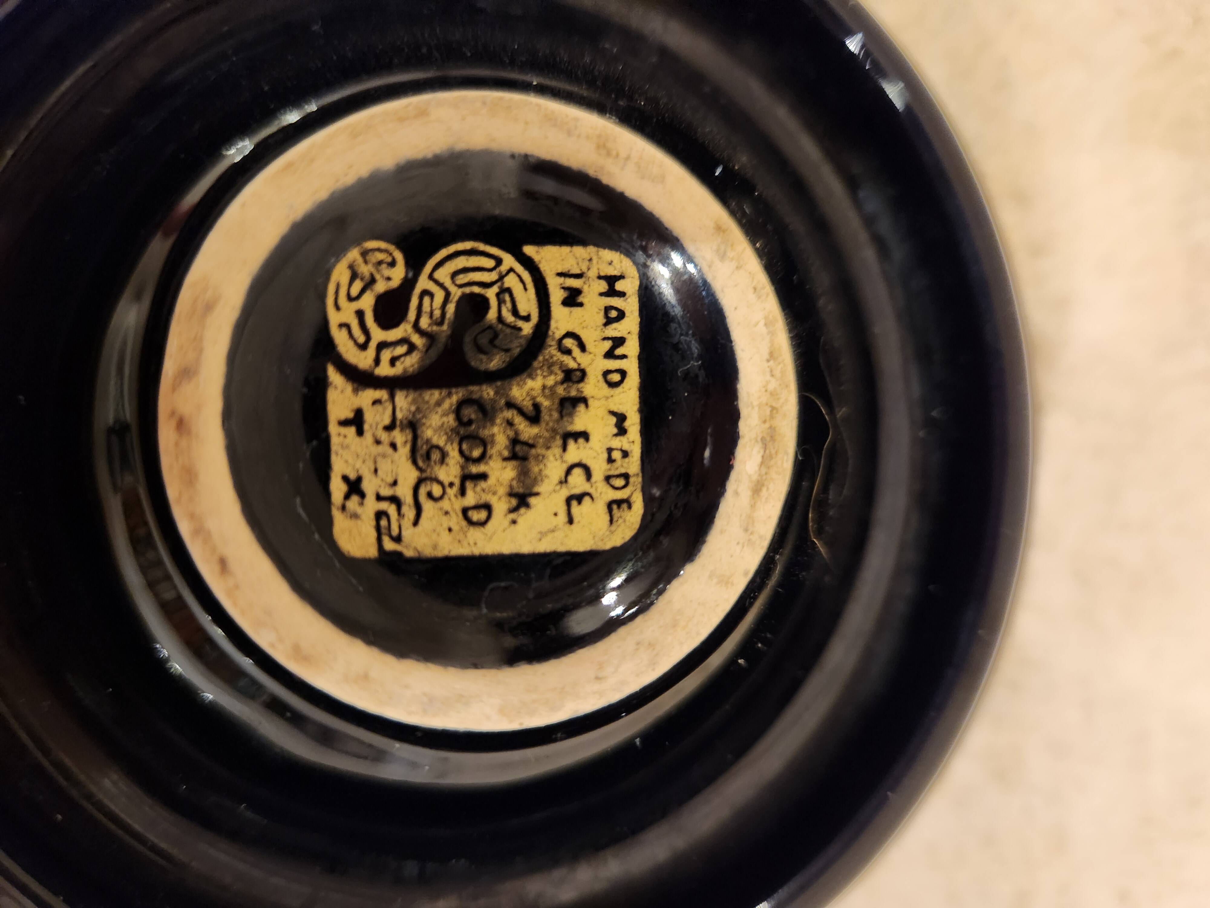 Small vintage ashtray in black ceramic with gold decoration in Greek style.