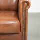 Armchair made of sheepskin leather with refined decorative nail finish