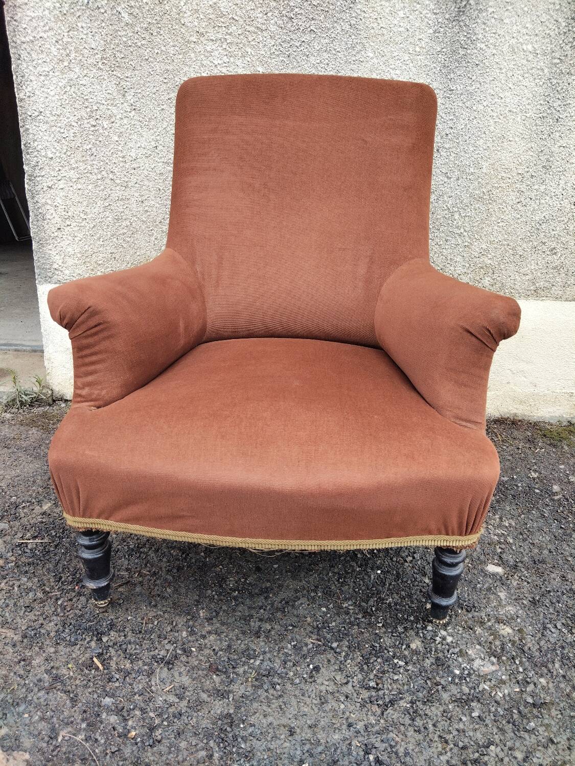 Antique brown velvet tub chair – turned legs and brass rings.