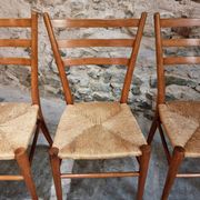 Set of 4 mid-century Italian dining chairs with woven seats, circa 1950–1970.