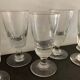 12 old glasses on foot at bistro or absinthe