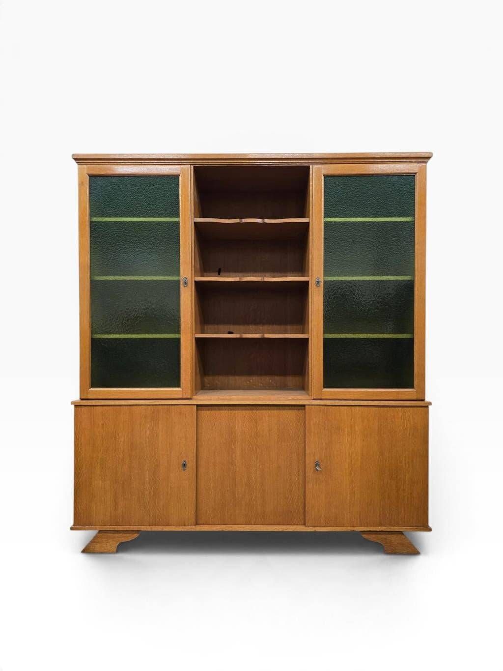 Vintage wooden display cabinet with green glass.