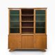 Vintage wooden display cabinet with green glass.