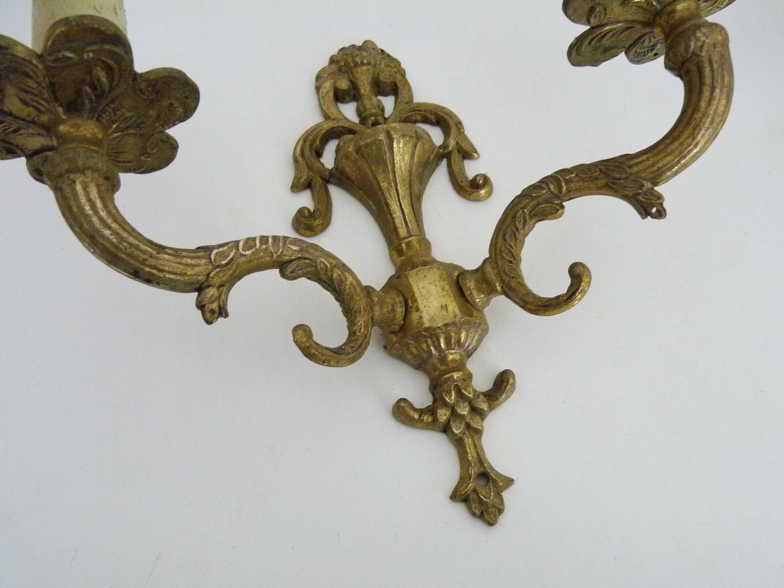 Pair of two-armed fire pot wall lights in gilded bronze.
