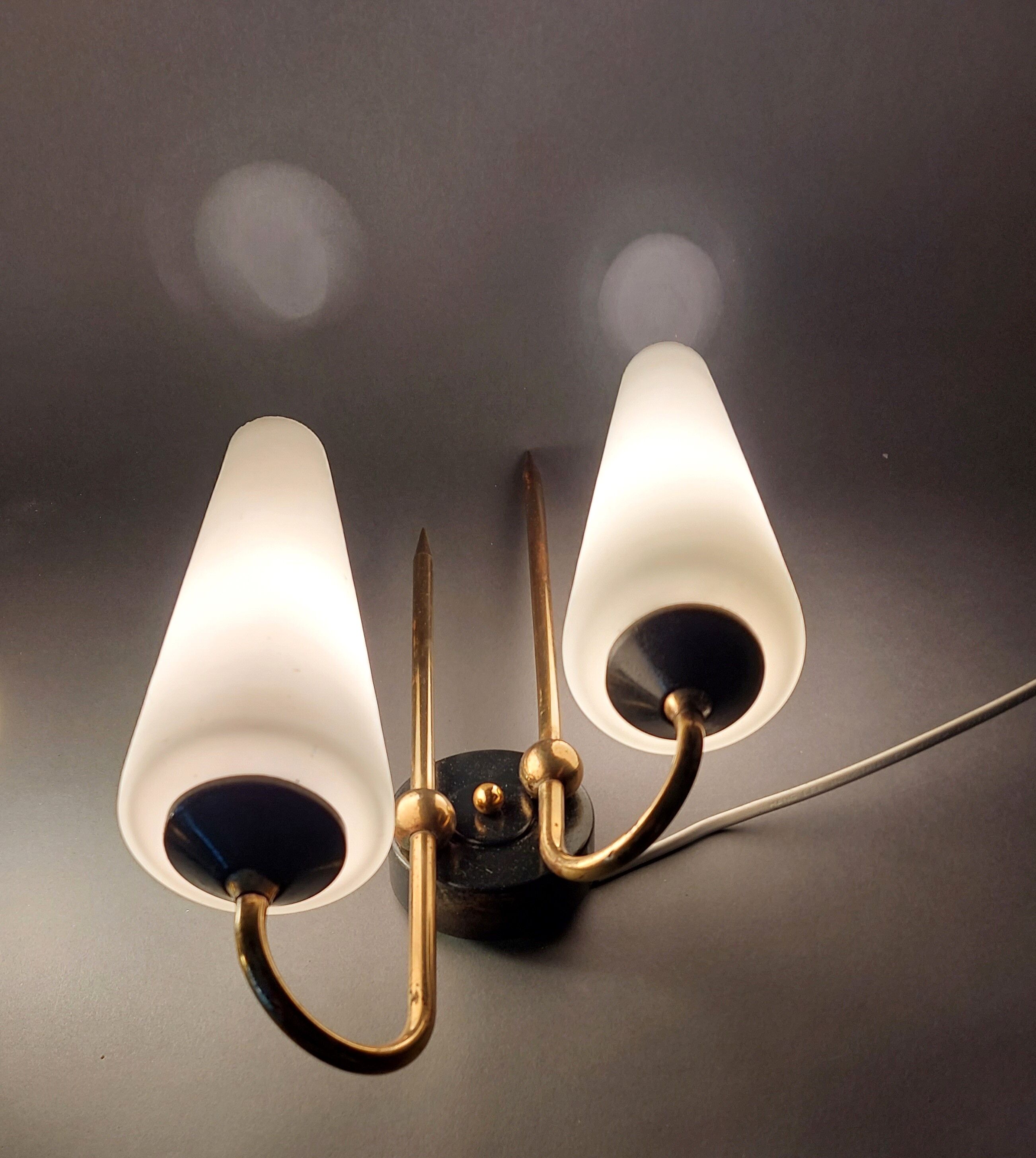 Pair of sconces in black metal and gilded brass 1960 Vintage.