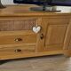 Buffet / TV unit in solid oak with a caned door.