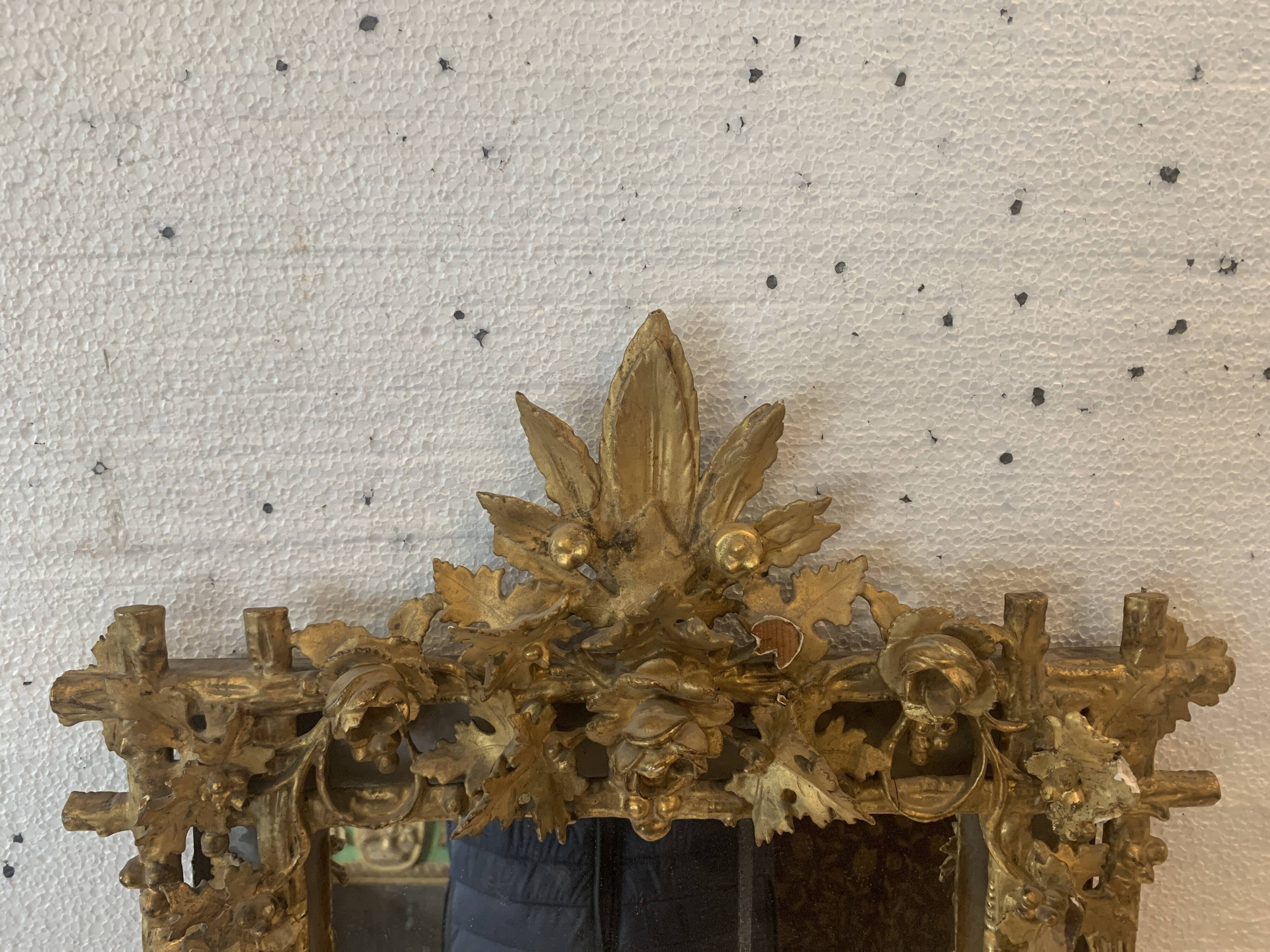 Louis XVI style mirror in carved wood and gilded with gold leaf, 19th century