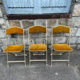 Three folding opera chairs in old gold velvet and brass structure