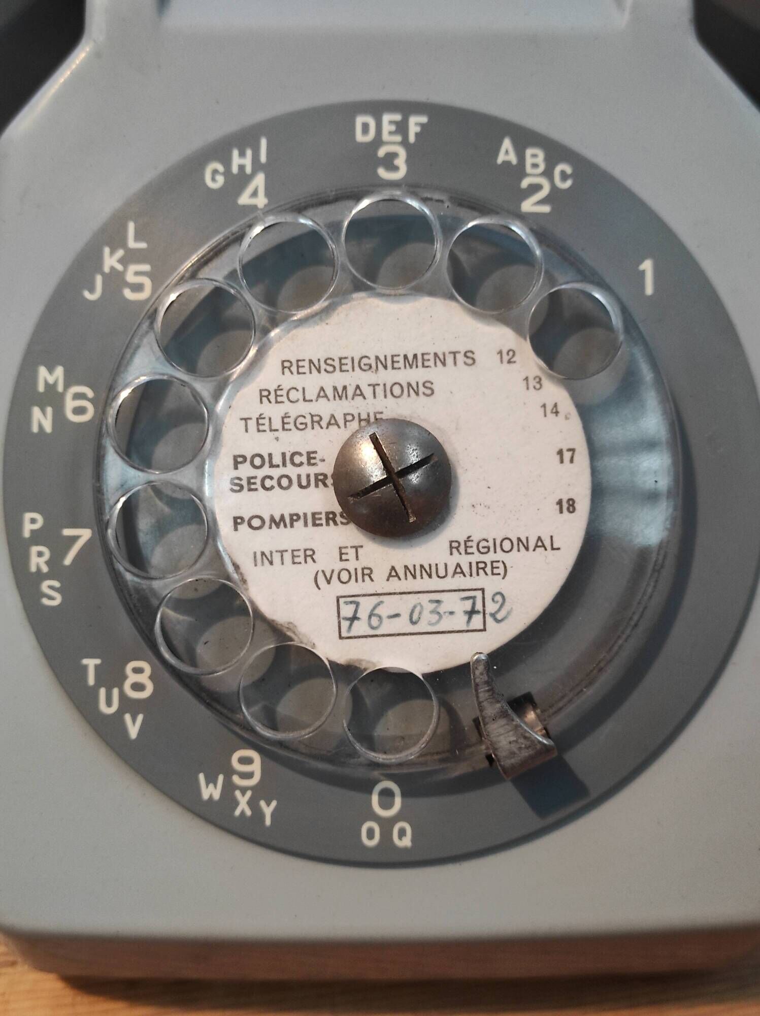 Old vintage wired dial phone with its earphone, gray color. Late 70s - early