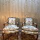 Pair of Louis XV style armchairs with floral fabric.