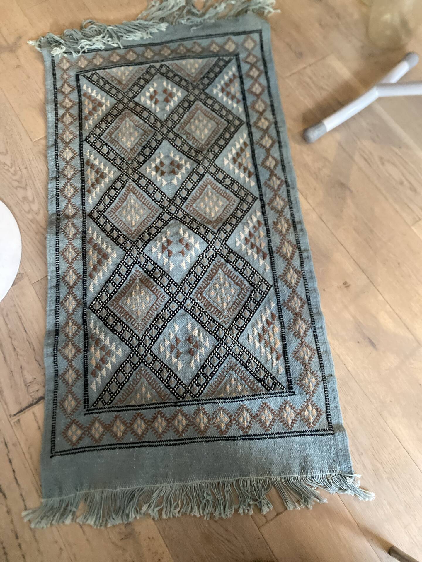 Handmade turquoise and beige wool rug, new.
