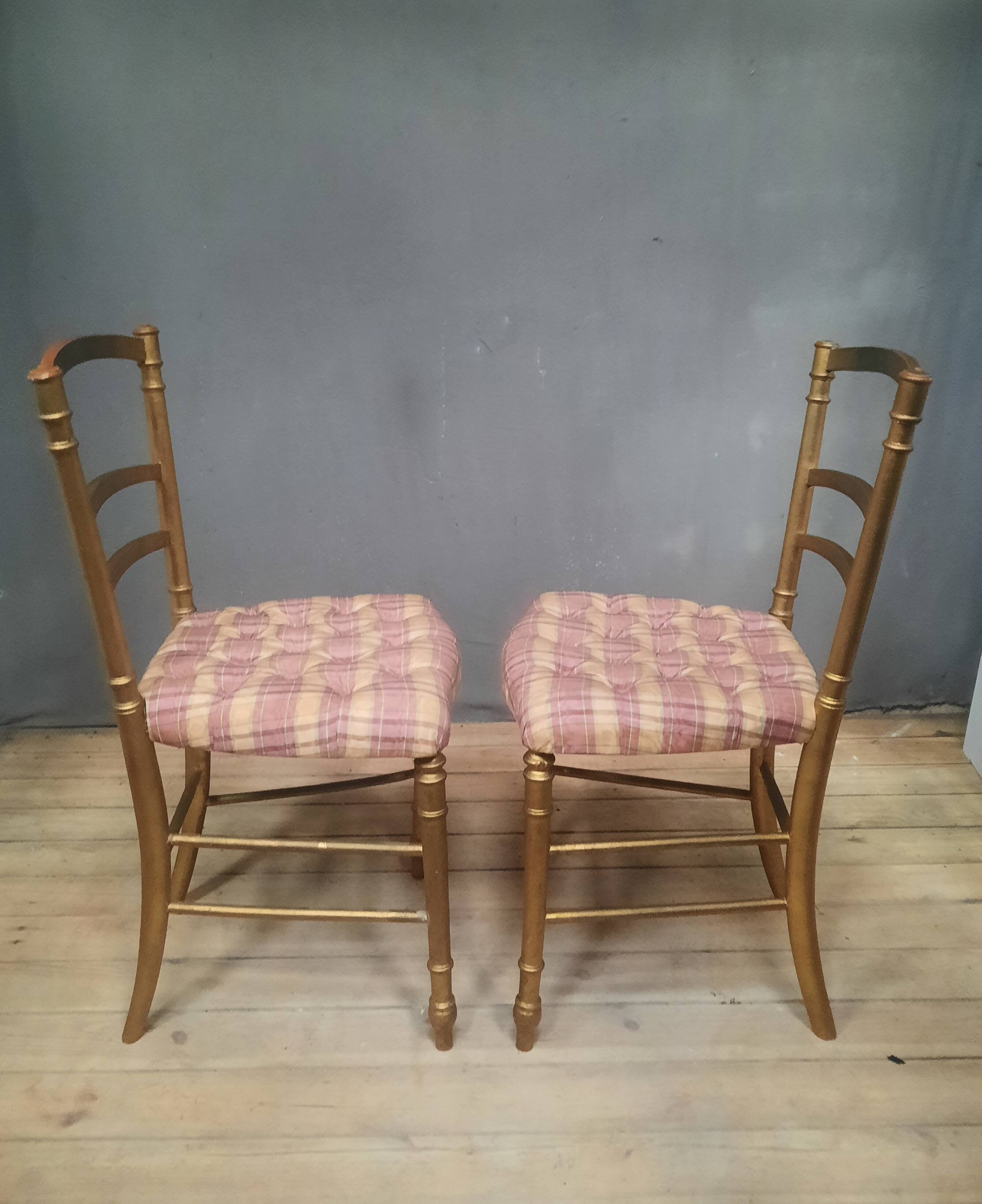 Pair of upholstered chairs in gilded wood