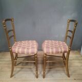 Pair of upholstered chairs in gilded wood
