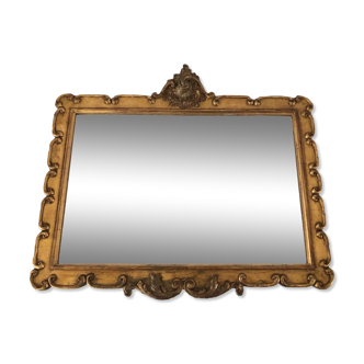 Old carved wooden frame and gilded stucco with mirror